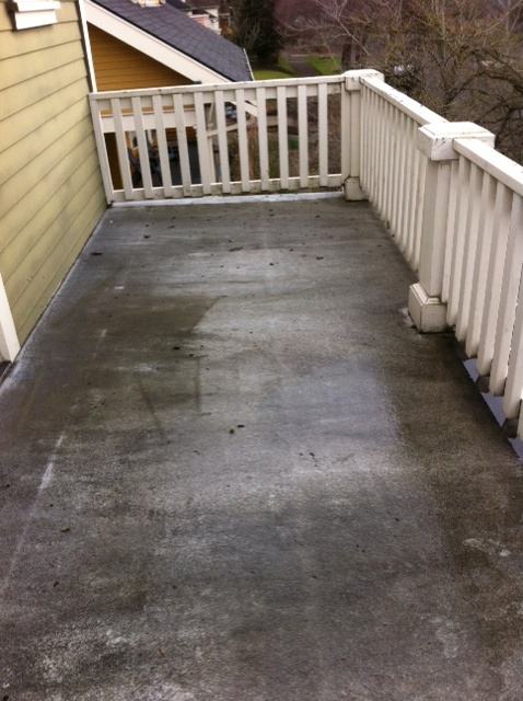 Deck surface before pressure washing, grimy and weathered
