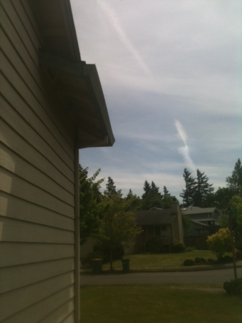 The full length of a replacement downspout run down the corner of the same home